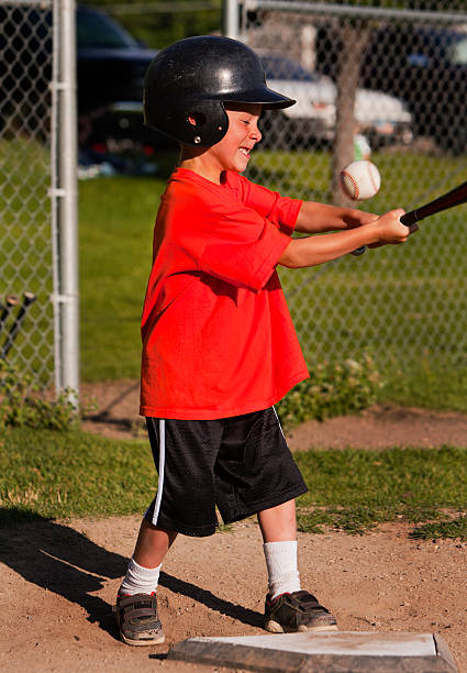 istock Boy swings bat at baseball 176892088
