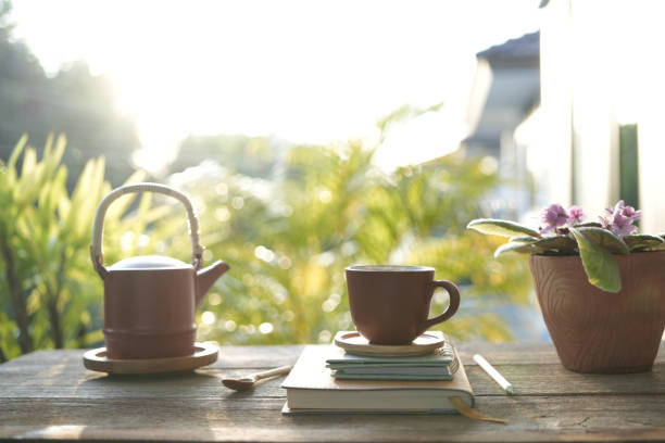 istock Brown tea cup and tea pot with brown plant pot and notebooks 1768928390