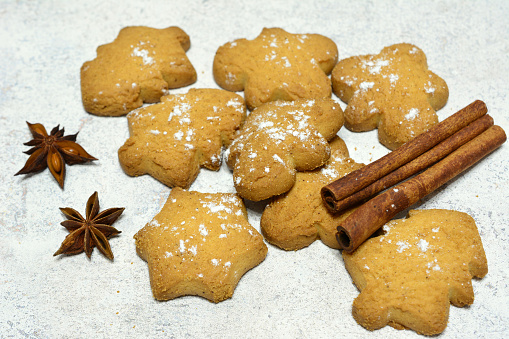 christmas cookies in the shape of star, fir and man with cinnamon and badian