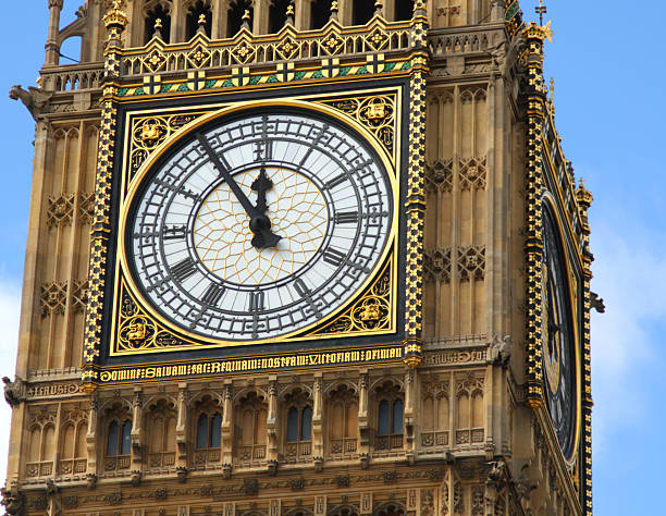 Almost Midday The clockface of Big Ben showing 5 to 12 its almost time stock pictures, royalty-free photos & images
