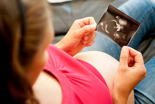 istock pregnant woman with ultrasound image 176894240