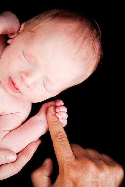 istock Newborn Baby Grasping Finger 176894272