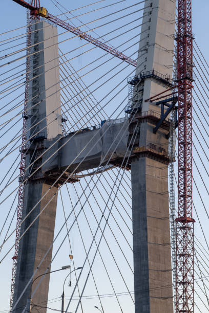 istock Crane and bridge construction against a blue sky background. 1768942780