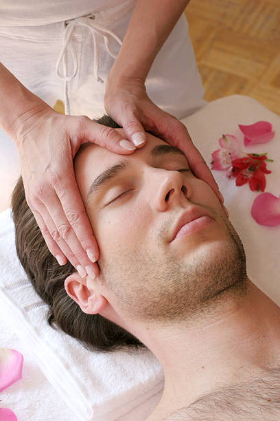 istock Gesichtsmassage with a young man's head being hand massaged 176894738