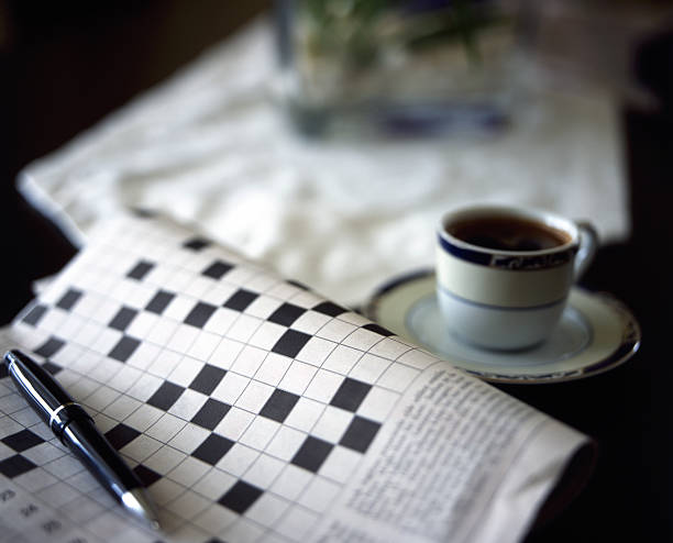 blank crossword puzzle and black coffee blankcrossword puzzle with a pen and black coffee crossword stock pictures, royalty-free photos & images