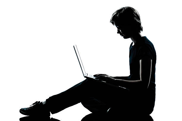 istock one young teenager boy girl silhouette computer computing lap 176895016