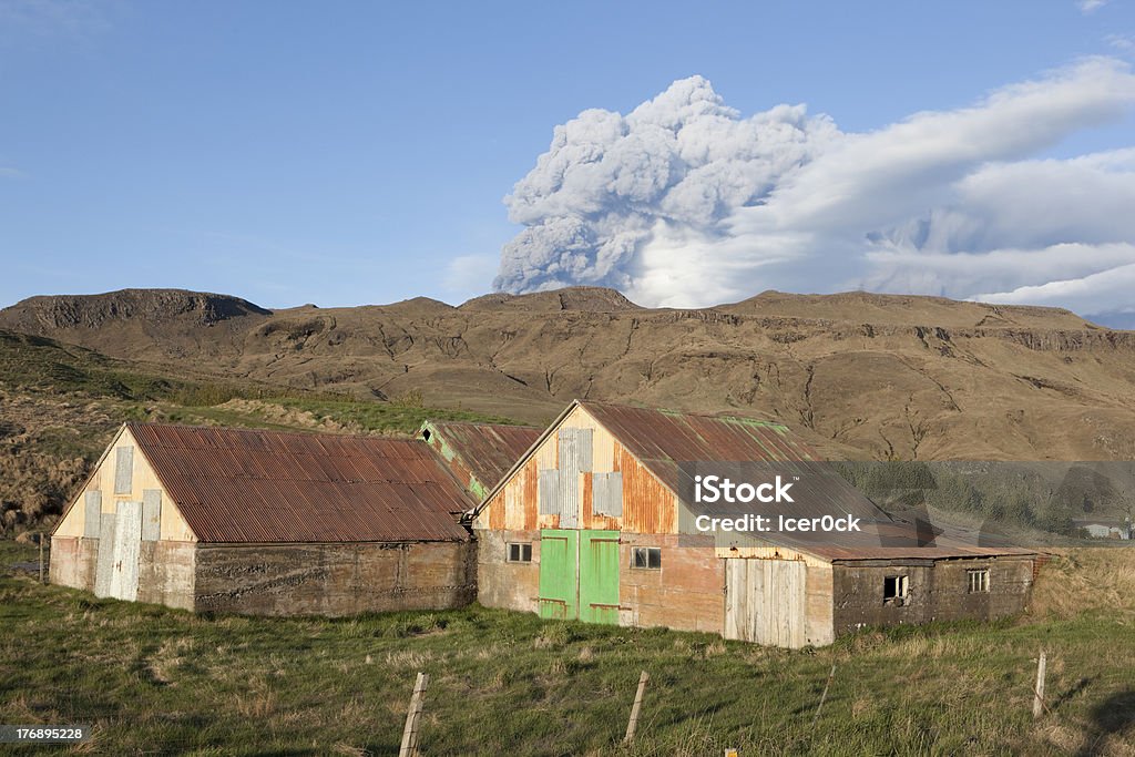 Volcano Eruption in Iceland Ash Sky and barn Volcanic activity at the top crater on Mt. Eyjafallajokull in south Iceland. This have been blocking air traffic in the world. barn is abandon. Erupting Stock Photo