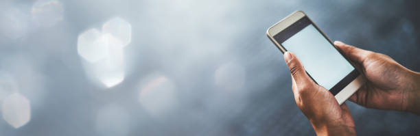 Person, hands and phone screen on mockup for social media, communication or networking on banner. Closeup of user with mobile smartphone app, display or advertising technology on bokeh background