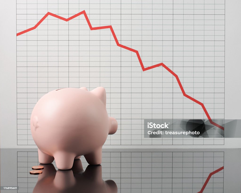 worried piggy piggy bank worrying over financial chart Line Graph Stock Photo