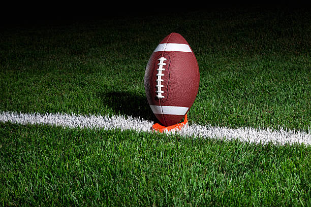 istock College football on tee at night 176895712