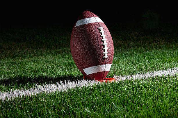 istock American football standing on tee at night 176895721