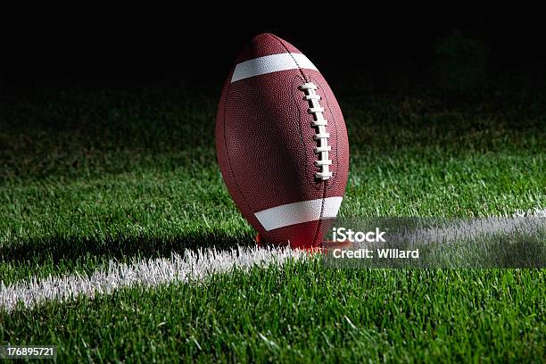 American Football Standing On Tee At Night Stock Photo - Download Image Now - American Football - Sport, American Football - Ball, Kick Off