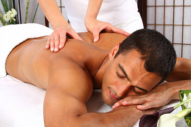 istock Woman giving man a back massage on massage table 176896034