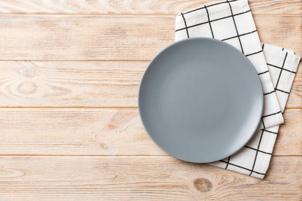 istock Top view on colored background empty round gray plate on tablecloth for food. Empty dish on napkin with space for your design 1768962009