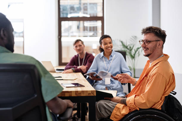 istock Man with disability sitting at meeting in office 1768963789