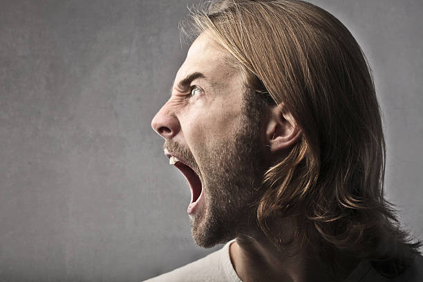 istock Angry man with long hair and beard screaming loudly 176896703