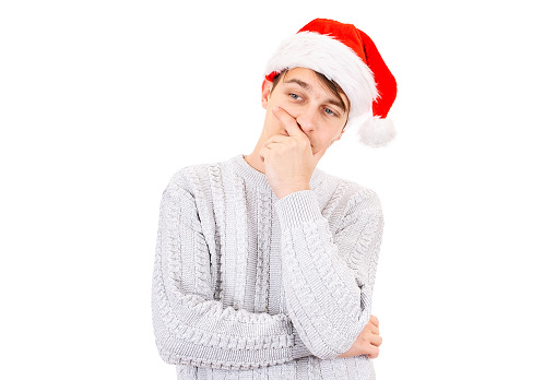 Pensive Young Man in Santa Hat is Thinking Isolated on the White Background