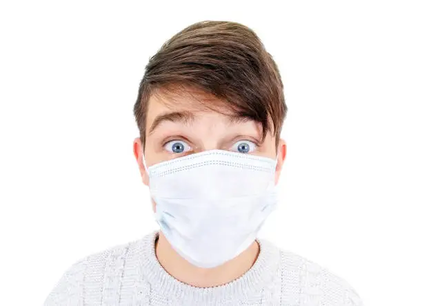 Shocked Young Man in the Surgical Mask Isolated on the White Background closeup