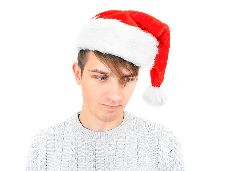 Unhappy Young in Santa Hat Portrait on the White Background closeup