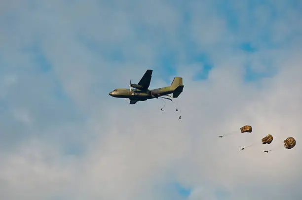 Lockheed C160 Hercules Transall Military aircraft dropping paratroopers during an airshow