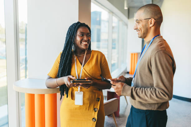 istock Cheerful business partners talking beside window in coworking office space 1768975545