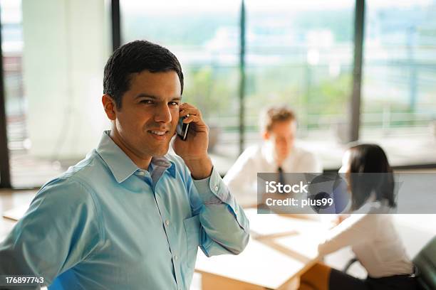 Latino Man Phone Call Business Meeting Stock Photo - Download Image Now - Business, Defocused, 20-29 Years