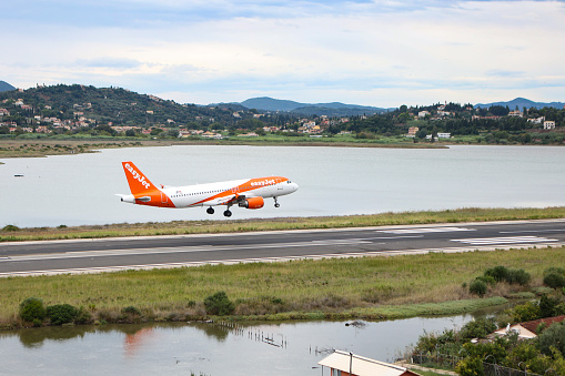 EasyJet airplane landing in Corfu airport in Greece. EasyJet is a British multinational low-cost airline group headquartered at London Luton Airport.