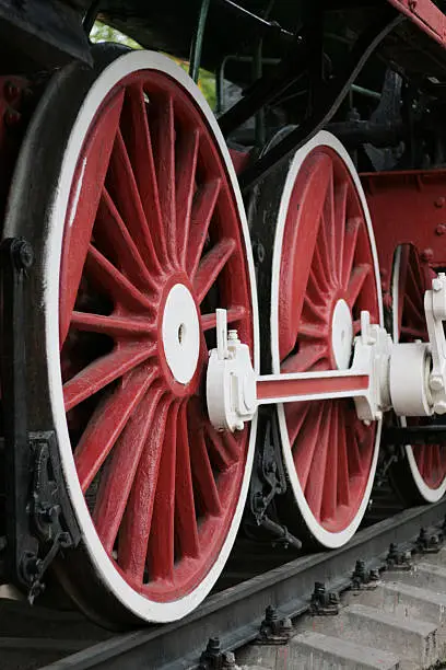 Big red locomotive wheels and old rails