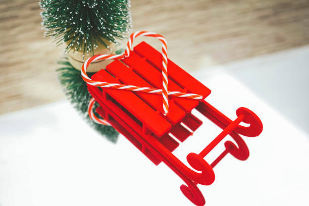 istock Classic christmas background with a red sled and a christmas tree over a mirror 1768991285