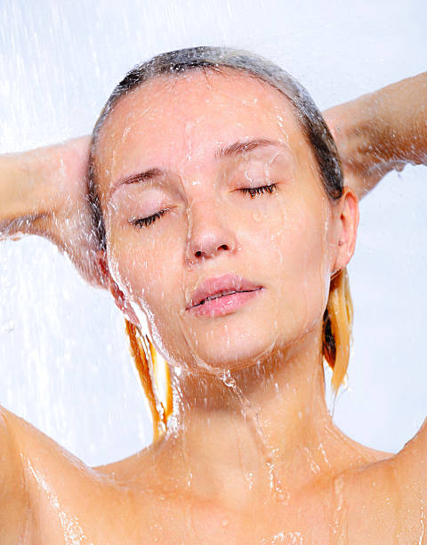 Portrait of young woman taking shower Portrait of beautiful pretty young woman taking shower shower women falling water human face stock pictures, royalty-free photos & images