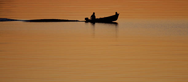 istock Sunset with the silhouette of a boat 176899614