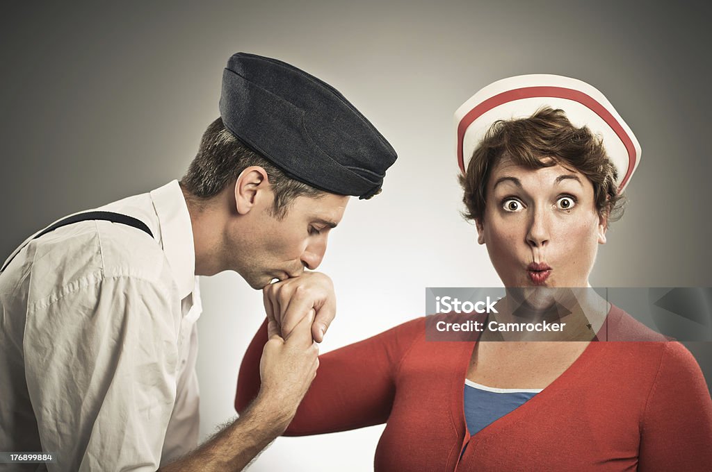 Retro Pilot Kissing Nurses Hand Retro Navy pilot kissing female nurses hand. Thanks to members stacey_newman & ohdub for posing. Kissing Hand Stock Photo