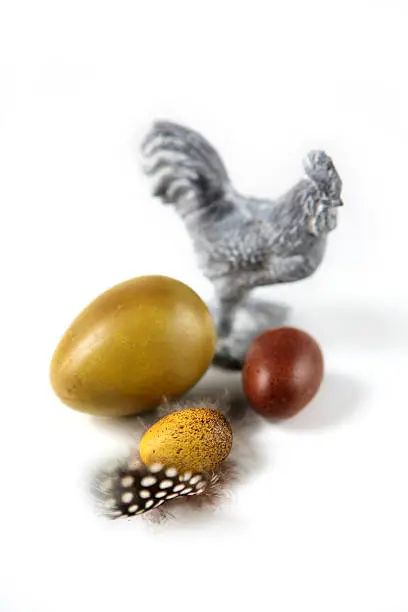 Ironwork chicken in white with three faux eggs and feather