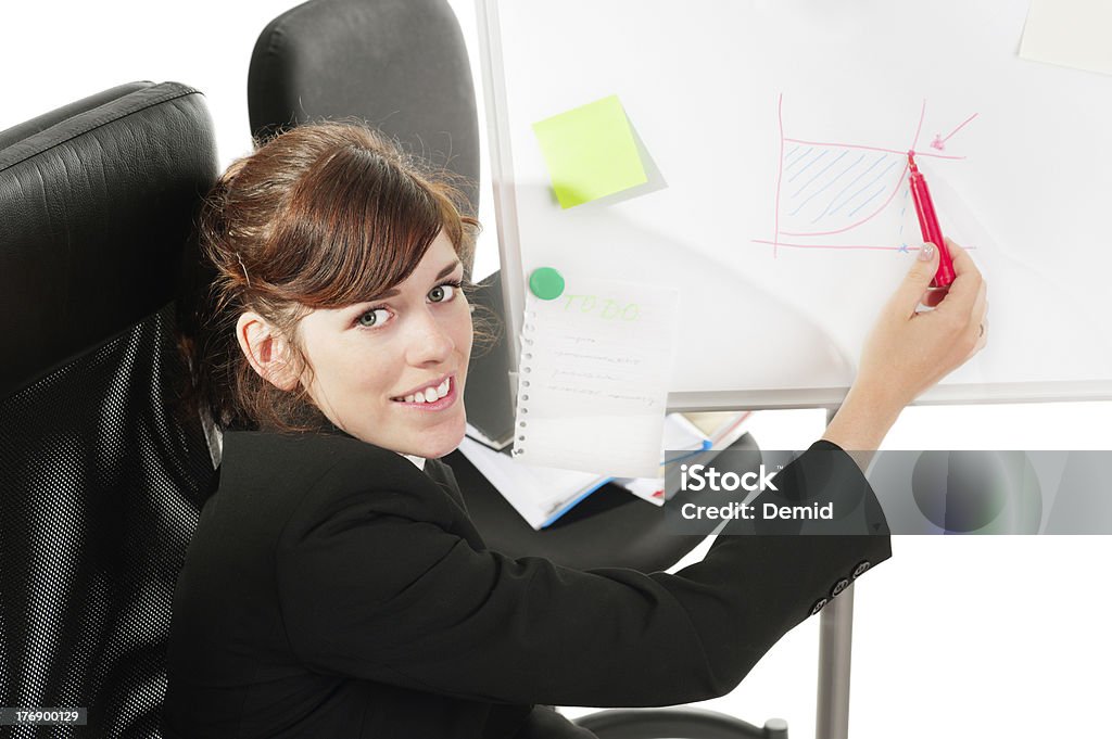 Business lady at a whiteboard Pretty business lady or student showing a graph at a whiteboard. Adult Stock Photo