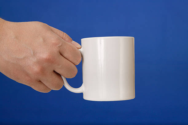 istock Hand holding a coffee mug on bluescreen chromakey 176900780