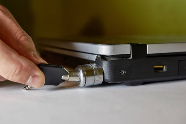 istock The man locks the laptop with a special anti-theft lock. 1769010610
