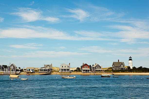 cape cod: houses by the sea "houses and lighthouse by the sea near hyannis port, massachusetts, usa. click for more:aocean/seaai" cape cod photos stock pictures, royalty-free photos & images