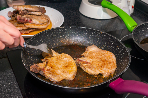 Cooking perfection: Pork steaks in the pan.