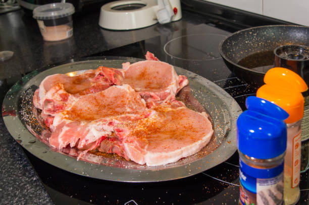Culinary experience: Seasoned pork chops ready to cook.