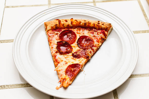 istock Greasy Slice Of Pepperoni Pizza 176901409