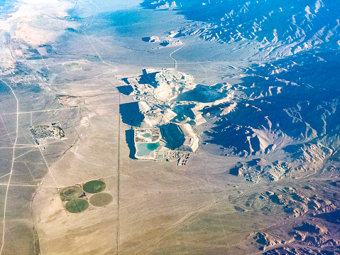 Aerial view of Round Mountain Gold Mine, Nevada, USA. Gold Hill Gold Mine in background. Both are open-pit mines.