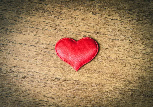 Red Heart Shape on the Old Wooden Board closeup
