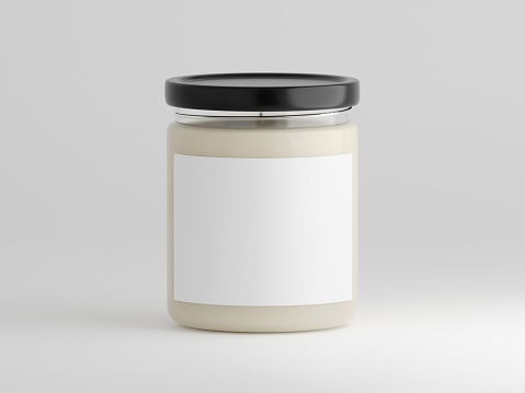 Minimalistic scented glass candle mockup with blank label for logo, text or design isolated on a plain white background as 3d rendering.