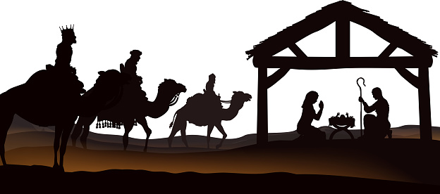 Traditional Christian Christmas Nativity Scene of baby Jesus in the manger with Mary and Joseph in silhouette and wise men