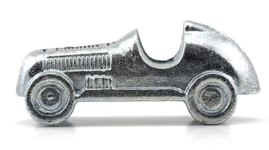 Studio shot of Vintage Toy Car isolated on white.Table game silver metal figure.