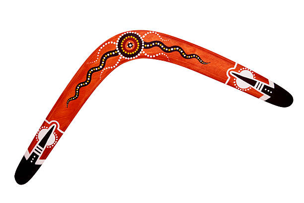 australian bumerang mit sonne isoliert - australia boomerang aboriginal aborigine stock-fotos und bilder