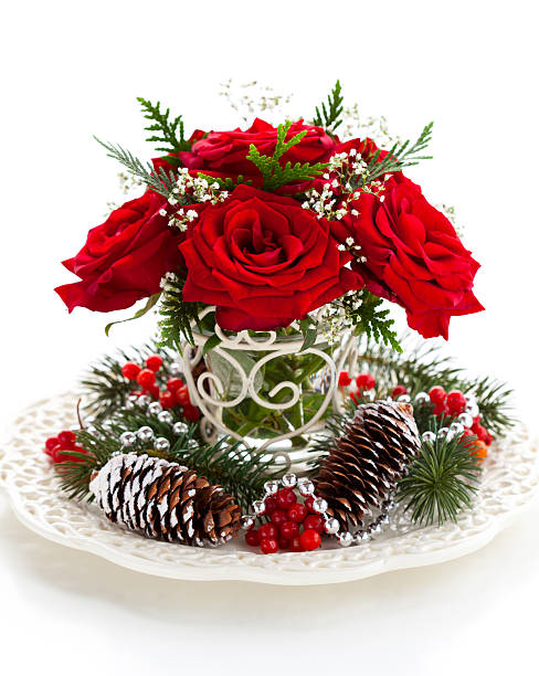 Christmas arrangement "Christmas arrangement of red roses,fir, holly and pine cones" rose christmas red white stock pictures, royalty-free photos & images