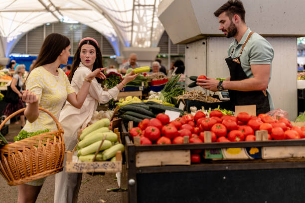 istock Two Women Discover Nutrient-Rich Vegetables, Guided by an Accomplished Vendor 1769050373