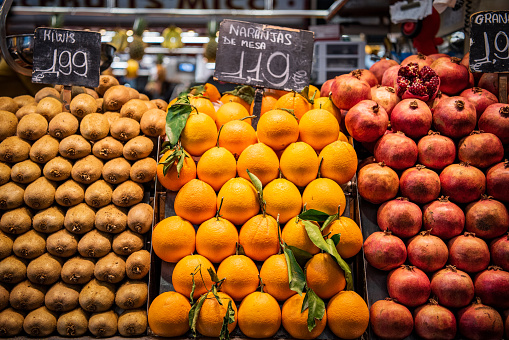 Close up, top view. Different multicolor fruits on the counter at a Spanish bazaar Mercado de La Boqueria.