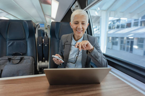istock Senior woman working on laptop in the train 1769065721